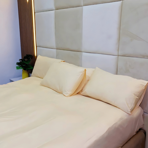 Plain yellow 200 thread count cotton bedsheet set with 4 pillowcases from Wowlifestyle, displayed on a neatly styled 6x6 bed