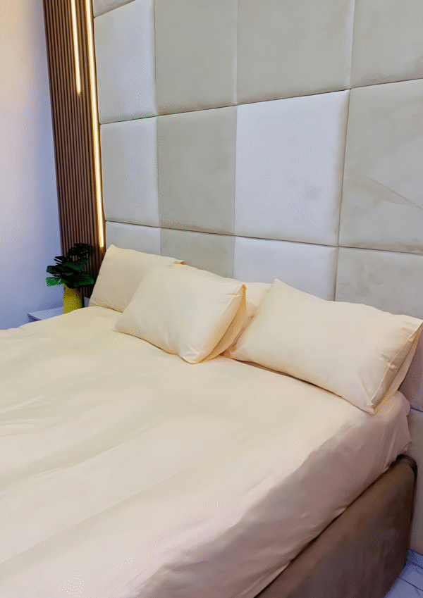 Plain yellow 200 thread count cotton bedsheet set with 4 pillowcases from Wowlifestyle, displayed on a neatly styled 6x6 bed
